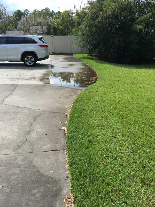 The edge of a clients driveway, before putting in French drainage